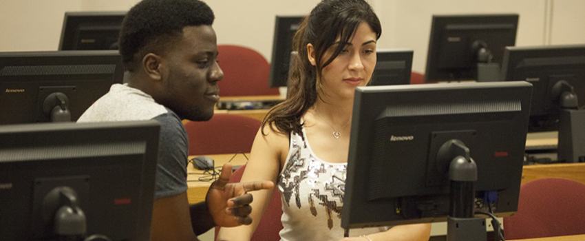 A male and female student working on computer