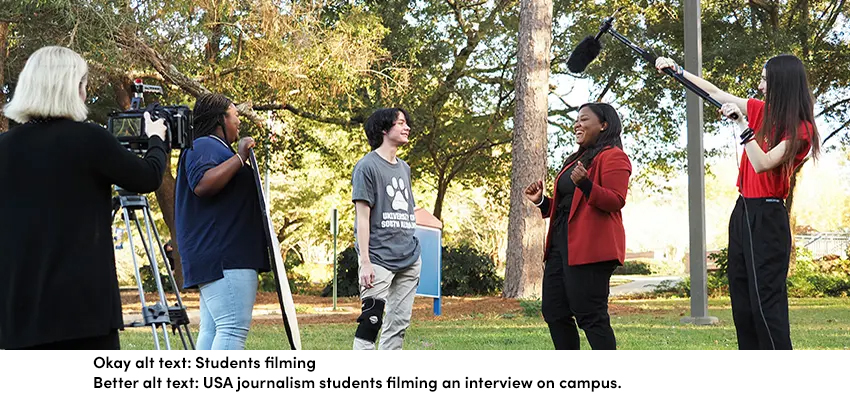 USA journalism students filming an interview on campus.