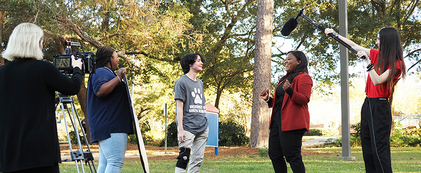 USA journalism students filming an interview on campus.