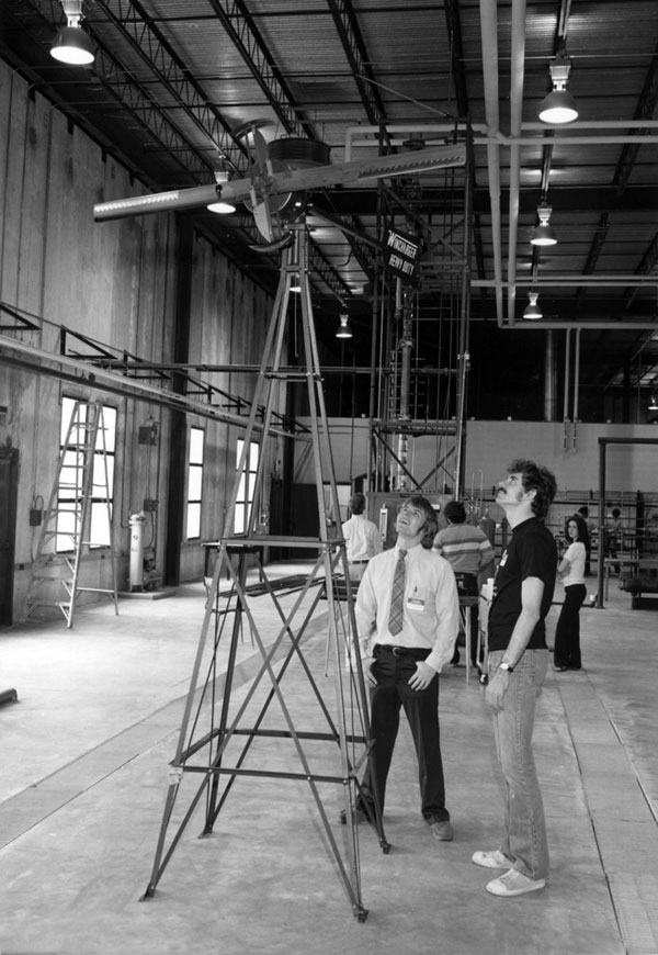 Two men gaze at equipment during a College of Engineering open house, 1981.