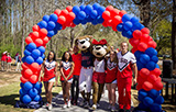Southpaw, Ms Pawla and cheerleaders walking through balloon banner