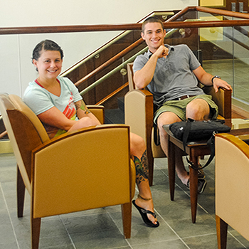 Two students sitting in common area of Shelby Hall