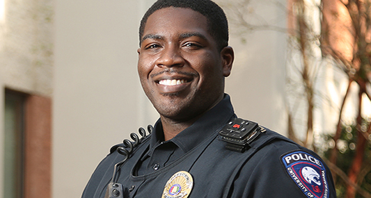 Police Officer smiling in uniform.