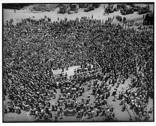 V-E Day 5/20/1945, a large crowd of ADDSCO workers gathers for events celebrating Allied victory in Europe. Alabama Dry Dock and Shipbuilding Collection, The Doy Leale McCall Rare Book and Manuscript Library, University of South Alabama