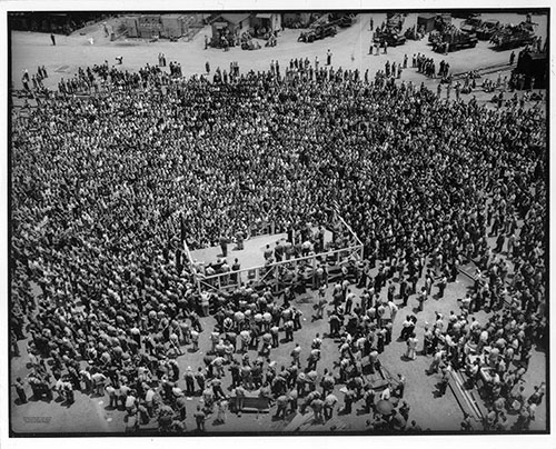 V-E Day 5/20/1945, a large crowd of ADDSCO workers gathers for events celebrating Allied victory in Europe. Alabama Dry Dock and Shipbuilding Collection, The Doy Leale McCall Rare Book and Manuscript Library, University of South Alabama