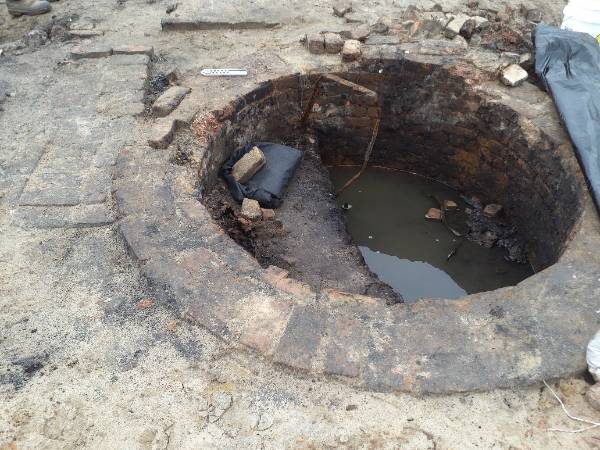 A brick cistern located in the southwestern corner of the site where the Sash and Door Company was located. It may have been related to that or to the earlier lumber mill at the site.