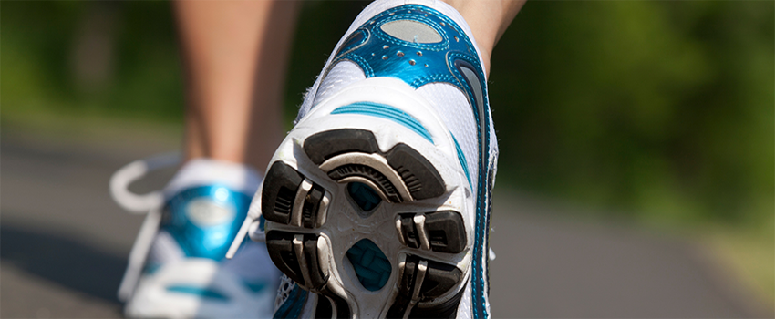 Tennis shoes walking on pavement.