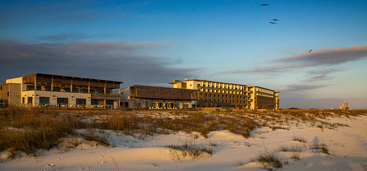 The Lodge at Gulf State Park with beach in front of it