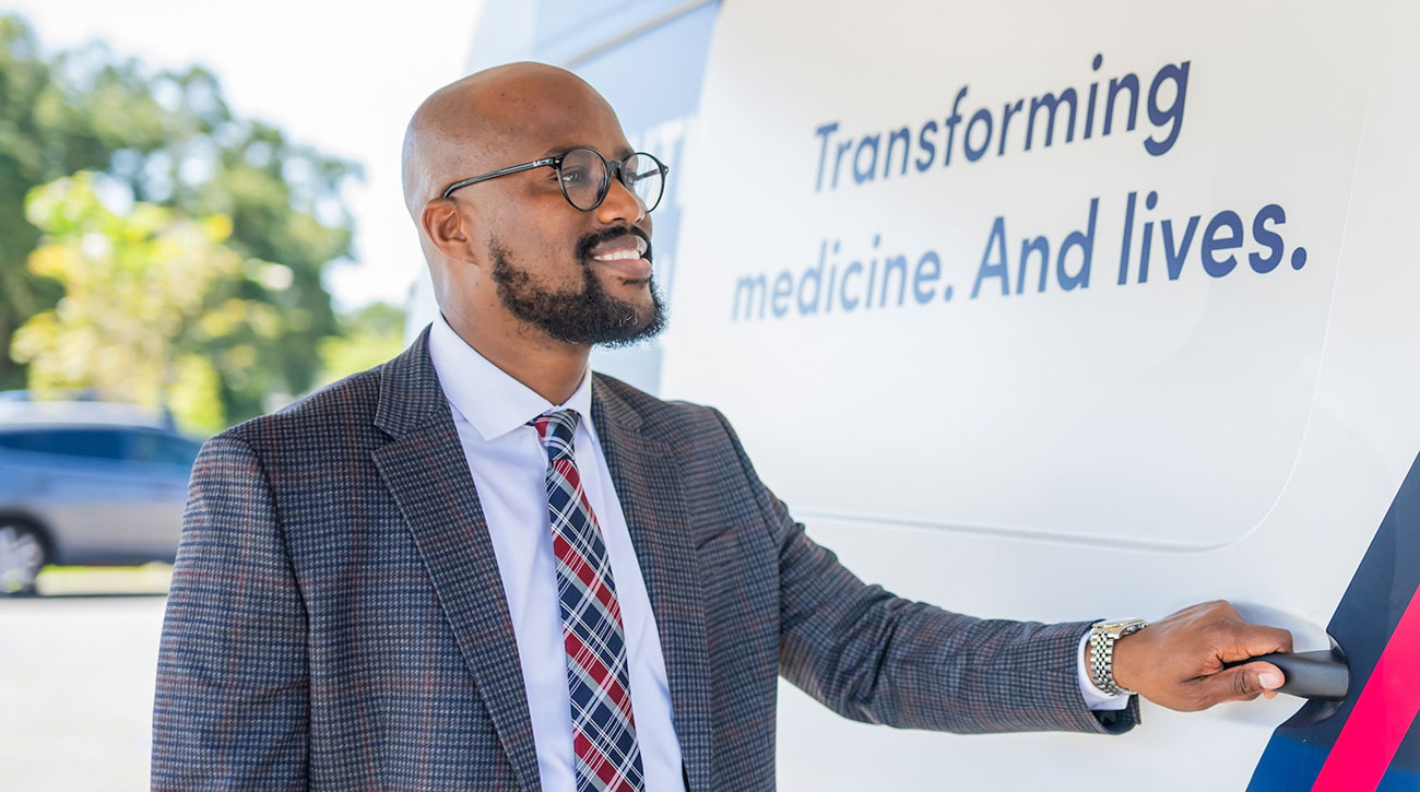 Antonio opening door of USA Health van.