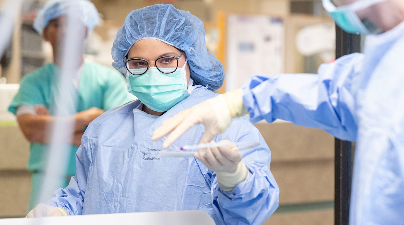 Medical workers in lab in scrubs.