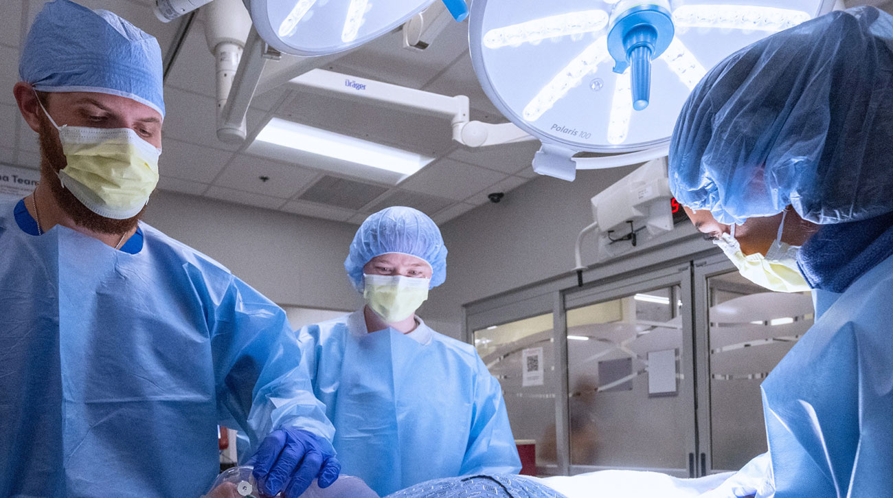 Surgery room with all medical workers in scrubs.